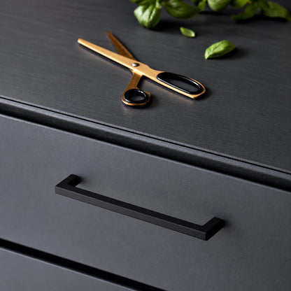 Modern kitchen cabinets featuring matte black square bar pulls